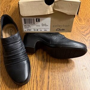 Clarks Emily Cove Black Ankle Boots with Leather Upper and Slip-On Design